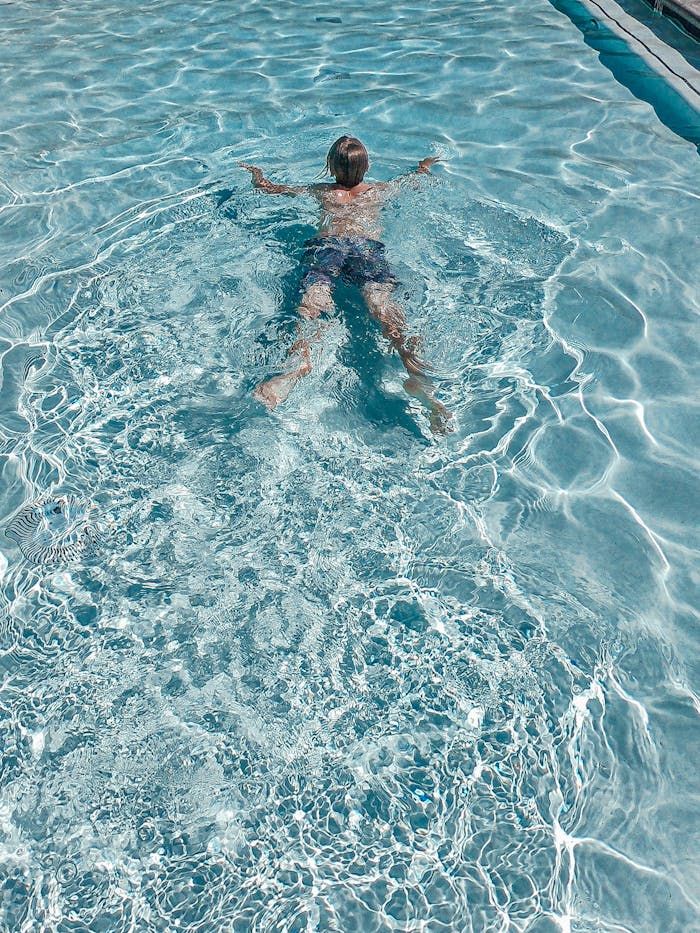 Person enjoying a swim in the pool