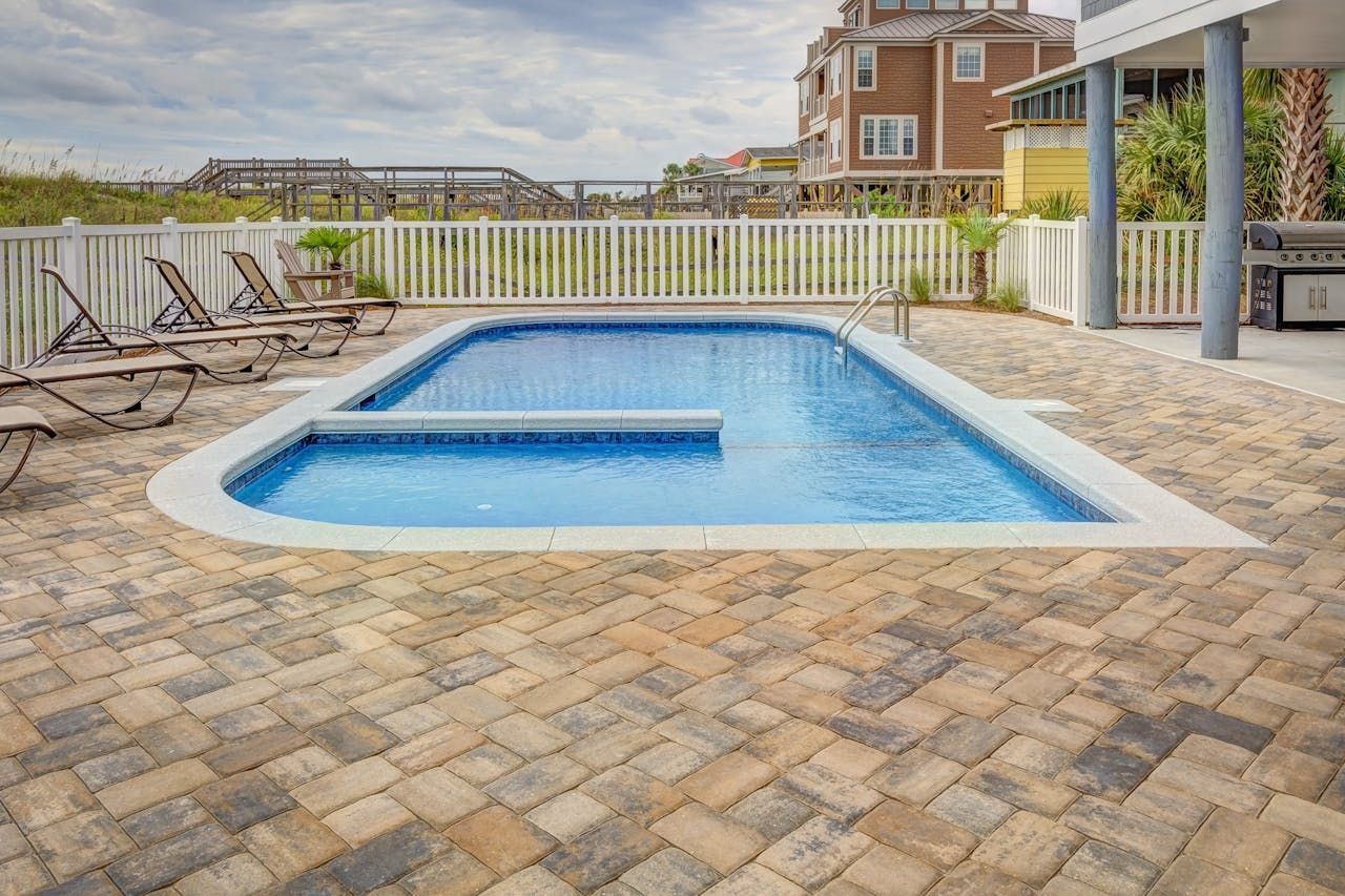 Swimming pool beside a fence
